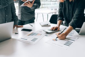 Business people analyzing investment graph meeting brainstorming and discussing plan in meeting room, investment concept